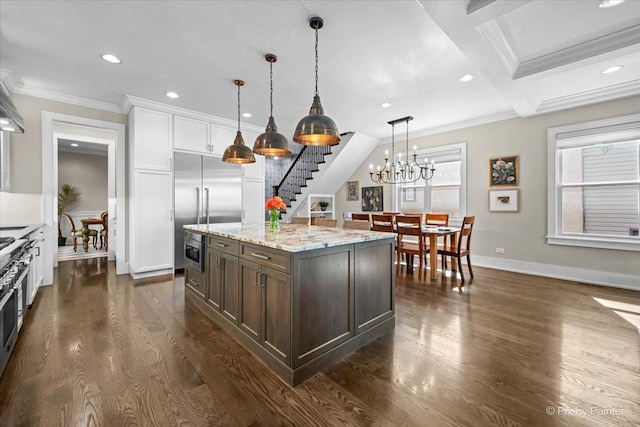 2426 W Warner Ave, Chicago, IL 60618 - kitchen featuring built in appliances, crown molding, dark wood-type flooring, baseboards, and dark brown cabinetry