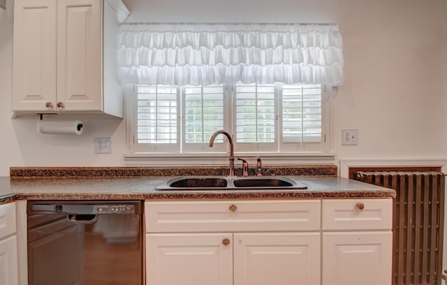 110 N Newton St, Goodland, IN 47948 - kitchen featuring dishwashing machine, a sink, dark countertops, radiator heating unit, and white cabinets