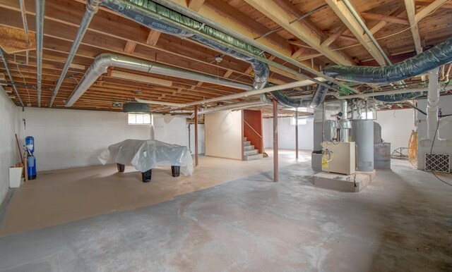 110 N Newton St, Goodland, IN 47948 - below grade area featuring stairway, heating unit, and gas water heater