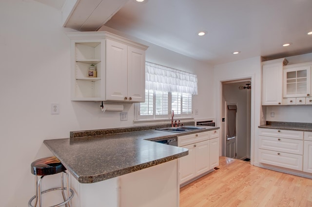 110 N Newton St, Goodland, IN 47948 - kitchen featuring a sink, dark countertops, white cabinetry, a peninsula, and recessed lighting