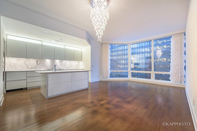 401 N Wabash Ave Unit 39G, Chicago, IL 60611 - kitchen featuring modern cabinets, dark wood-style flooring, backsplash, a chandelier, and baseboards