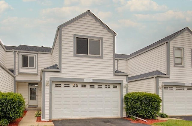 1716 Waters Edge Dr Unit 1716, Minooka, IL 60447 - view of front of property with a garage, asphalt driveway, and roof with shingles