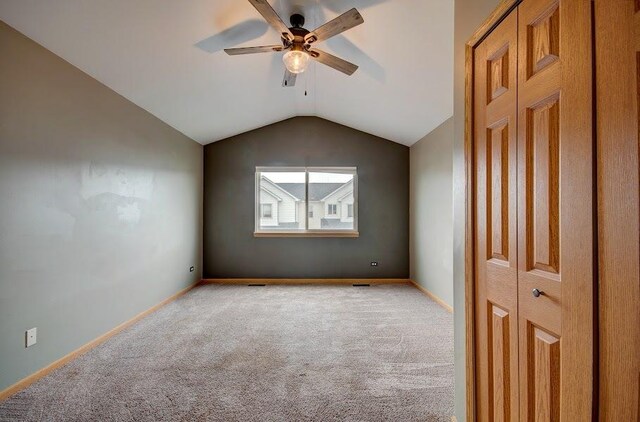 1716 Waters Edge Dr Unit 1716, Minooka, IL 60447 - spare room with ceiling fan, light carpet, vaulted ceiling, and baseboards