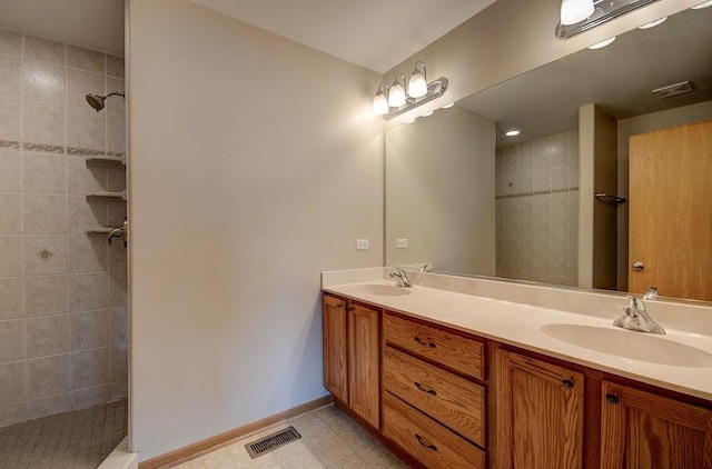 1716 Waters Edge Dr Unit 1716, Minooka, IL 60447 - bathroom with double vanity, tiled shower, and baseboards