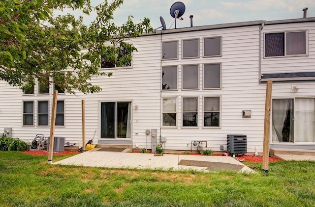 1716 Waters Edge Dr Unit 1716, Minooka, IL 60447 - back of house featuring cooling unit, a lawn, and a patio