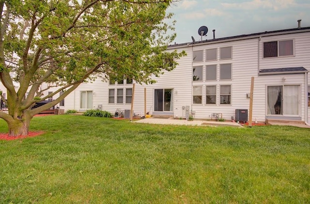 1716 Waters Edge Dr Unit 1716, Minooka, IL 60447 - rear view of property featuring central air condition unit and a yard
