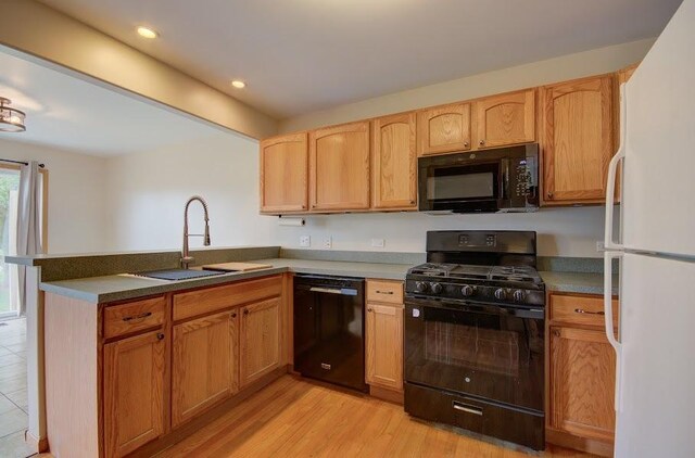 1716 Waters Edge Dr Unit 1716, Minooka, IL 60447 - kitchen with black appliances, a sink, a peninsula, light wood finished floors, and recessed lighting