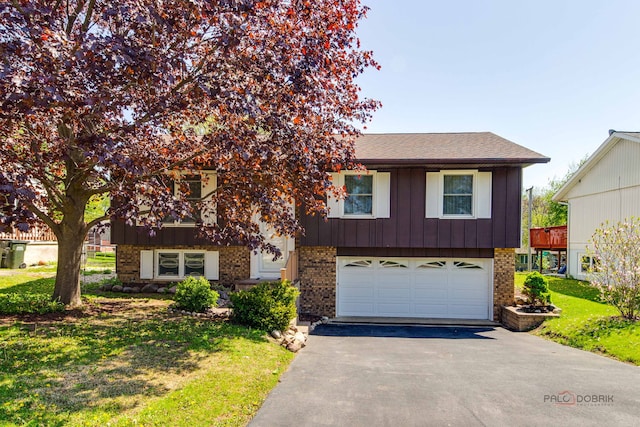 14 Wander Way, Lake In The Hills, IL 60156 - view of front of home with brick siding, driveway, a garage, and a front yard