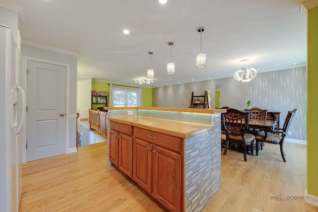 14 Wander Way, Lake In The Hills, IL 60156 - kitchen with white refrigerator with ice dispenser, light wood-style floors, pendant lighting, brown cabinets, and crown molding