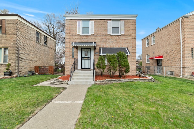 9026 S Colfax Ave, Chicago, IL 60617 - traditional-style house with brick siding and a front yard