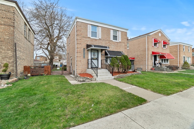 9026 S Colfax Ave, Chicago, IL 60617 - view of front facade featuring brick siding and a gate