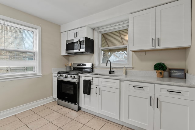9026 S Colfax Ave, Chicago, IL 60617 - kitchen with stainless steel appliances, a sink, plenty of natural light, and white cabinetry