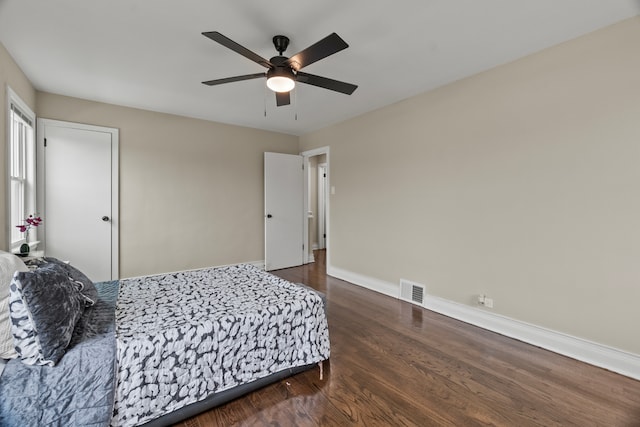 9026 S Colfax Ave, Chicago, IL 60617 - bedroom with dark wood-style floors, baseboards, and ceiling fan