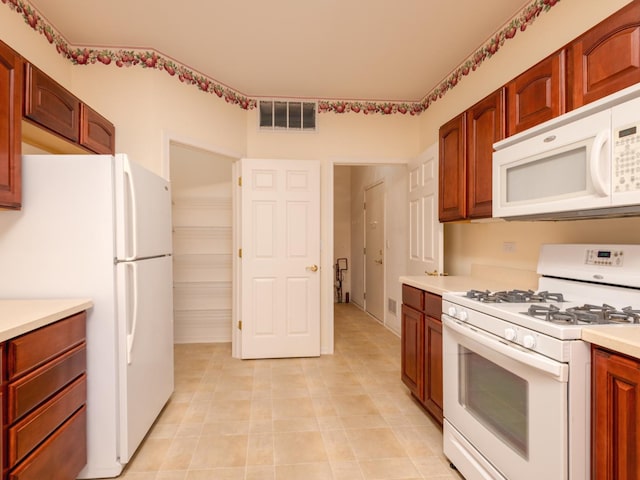 16565 Buckner Pond Way, Crest Hill, IL 60403 - kitchen with white appliances, light countertops, and light tile patterned floors