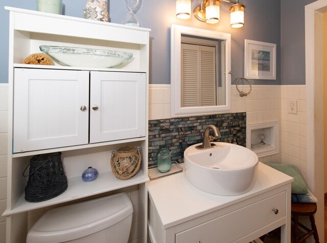 431 Griswold St, Elgin, IL 60123 - bathroom featuring vanity, toilet, tile walls, and a wainscoted wall