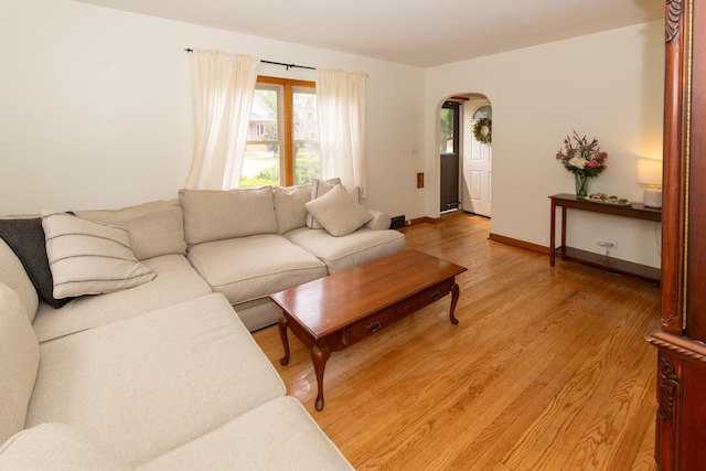 431 Griswold St, Elgin, IL 60123 - living room featuring arched walkways, light wood-type flooring, and baseboards