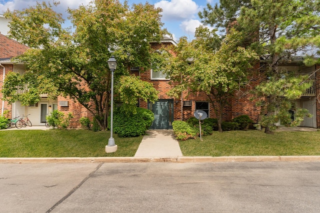 1384 Cunat Ct Unit 1B, Lake In The Hills, IL 60156 - obstructed view of property featuring a front lawn and brick siding