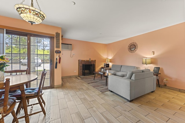 1384 Cunat Ct Unit 1B, Lake In The Hills, IL 60156 - living room featuring light wood-style flooring, baseboards, and an AC wall unit