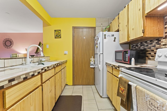 1384 Cunat Ct Unit 1B, Lake In The Hills, IL 60156 - kitchen with electric range, a sink, backsplash, light tile patterned floors, and light countertops