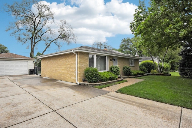 4N221 7th Ave, Addison, IL 60101 - view of front of property with brick siding, a detached garage, a front lawn, and a chimney