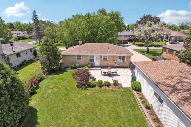 4N221 7th Ave, Addison, IL 60101 - back of property featuring brick siding, a patio, a fenced backyard, a residential view, and a chimney