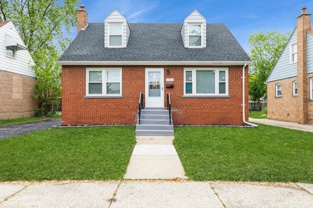 17916 Exchange Ave, Lansing, IL 60438 - view of front of property featuring brick siding, a shingled roof, a chimney, and a front lawn