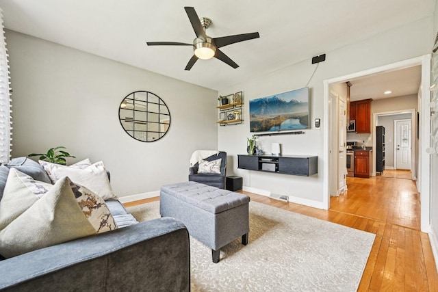 2741 N 75th Ave, Elmwood Park, IL 60707 - living room with light wood-type flooring, ceiling fan, and baseboards