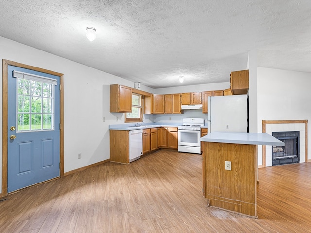119 SE Brandywine Dr, Poplar Grove, IL 61065 - kitchen with white appliances, under cabinet range hood, a textured ceiling, light wood-style flooring, and light countertops