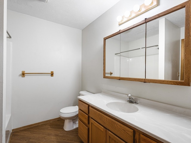 119 SE Brandywine Dr, Poplar Grove, IL 61065 - full bath with wood finished floors, vanity, toilet, a textured ceiling, and baseboards