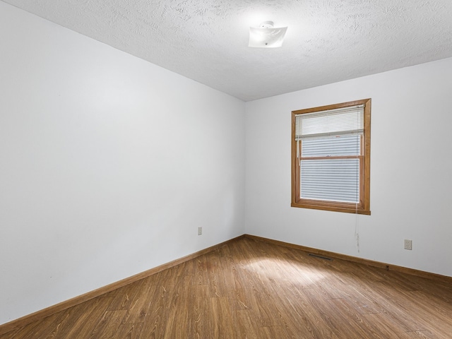 119 SE Brandywine Dr, Poplar Grove, IL 61065 - unfurnished room featuring wood finished floors, baseboards, and a textured ceiling