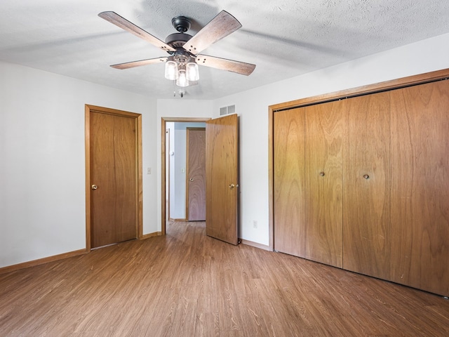 119 SE Brandywine Dr, Poplar Grove, IL 61065 - unfurnished bedroom with wood finished floors, baseboards, a closet, and ceiling fan