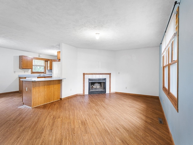 119 SE Brandywine Dr, Poplar Grove, IL 61065 - unfurnished living room featuring light wood-type flooring, baseboards, and a textured ceiling