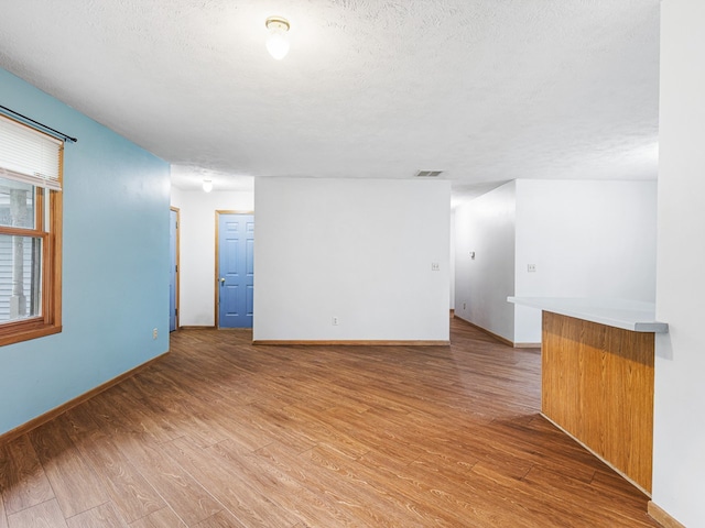 119 SE Brandywine Dr, Poplar Grove, IL 61065 - unfurnished room featuring light wood-style flooring, baseboards, and a textured ceiling