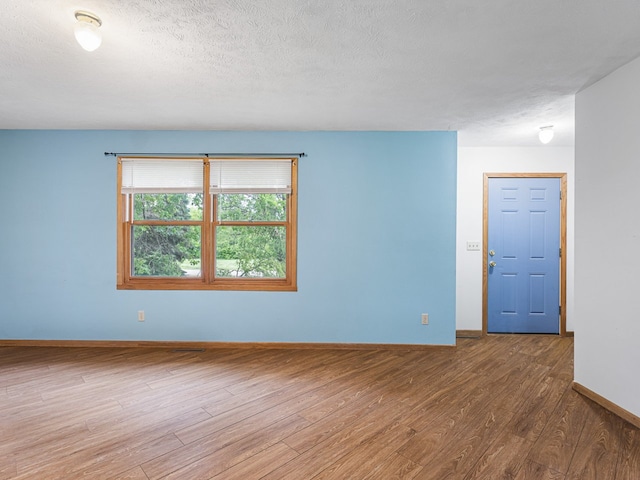 119 SE Brandywine Dr, Poplar Grove, IL 61065 - spare room featuring wood finished floors, baseboards, and a textured ceiling