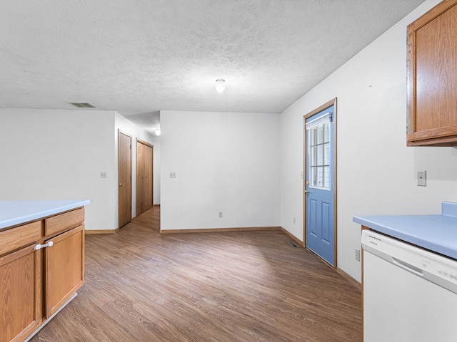 119 SE Brandywine Dr, Poplar Grove, IL 61065 - kitchen featuring dishwasher, light wood-type flooring, light countertops, a textured ceiling, and baseboards