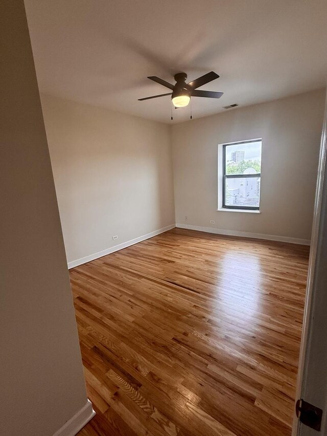 6324 S Kimbark Ave Unit 404, Chicago, IL 60637 - unfurnished room with wood finished floors, ceiling fan, and baseboards