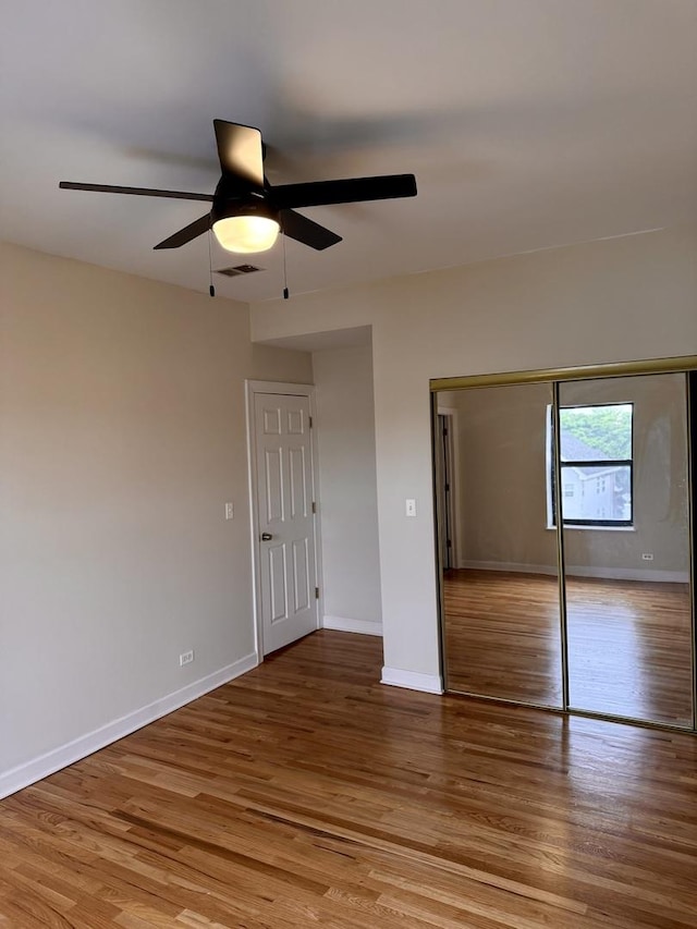 6324 S Kimbark Ave Unit 404, Chicago, IL 60637 - unfurnished bedroom featuring wood finished floors, baseboards, a closet, and ceiling fan