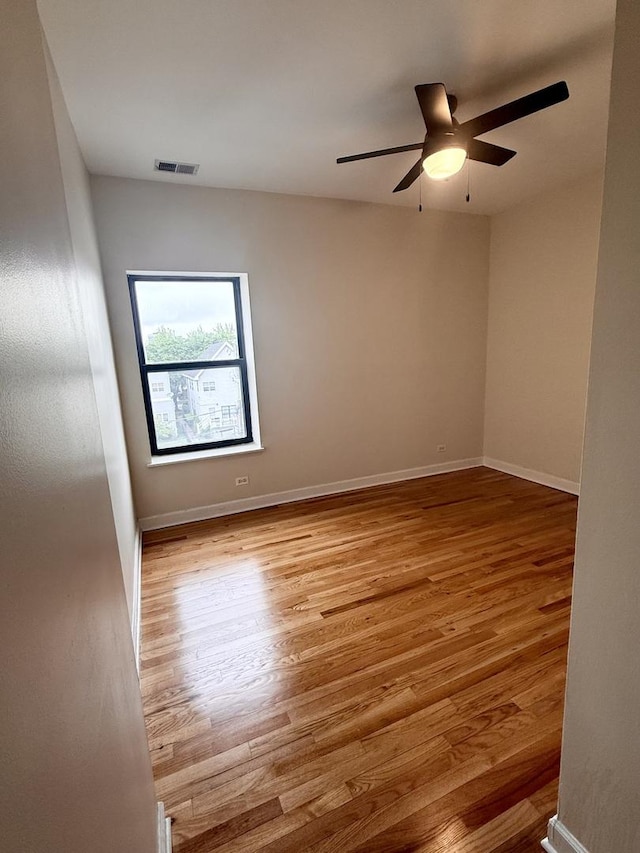 6324 S Kimbark Ave Unit 404, Chicago, IL 60637 - spare room with wood finished floors, ceiling fan, and baseboards