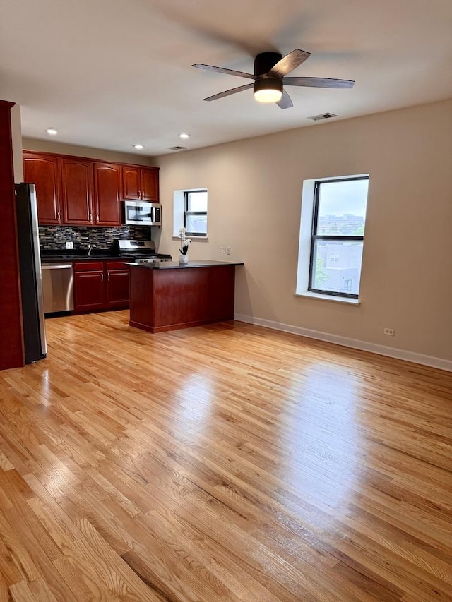 6324 S Kimbark Ave Unit 404, Chicago, IL 60637 - kitchen featuring appliances with stainless steel finishes, dark countertops, plenty of natural light, a peninsula, and recessed lighting