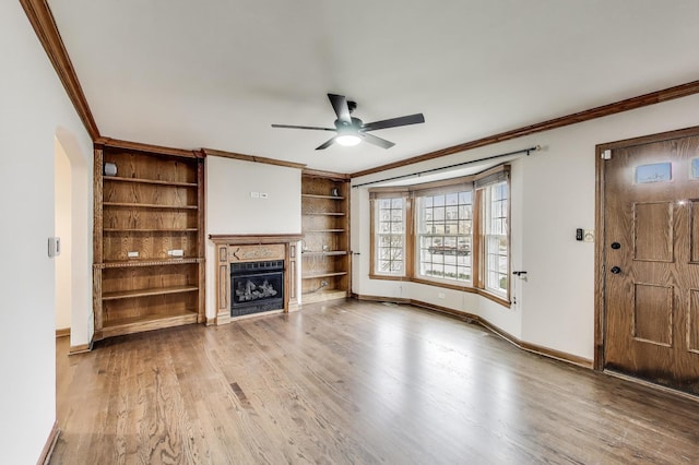 2004 Linden Ave, Park Ridge, IL 60068 - unfurnished living room featuring ornamental molding, ceiling fan, wood finished floors, built in shelves, and a fireplace