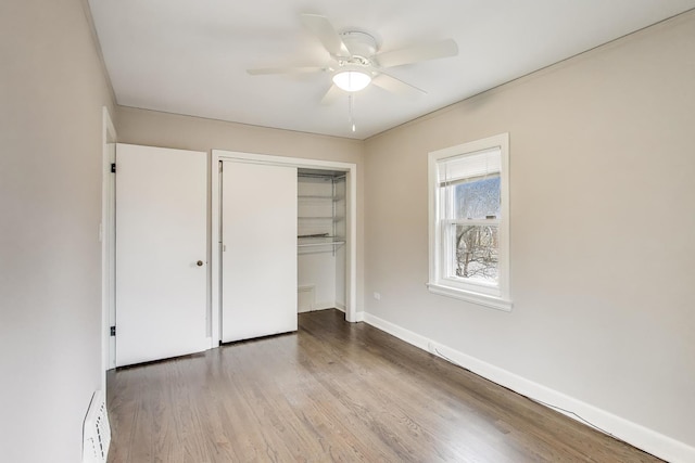 2004 Linden Ave, Park Ridge, IL 60068 - unfurnished bedroom with wood finished floors, a closet, baseboards, ceiling fan, and baseboard heating