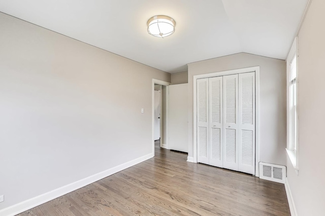 2004 Linden Ave, Park Ridge, IL 60068 - unfurnished bedroom featuring lofted ceiling, wood finished floors, baseboards, and a closet