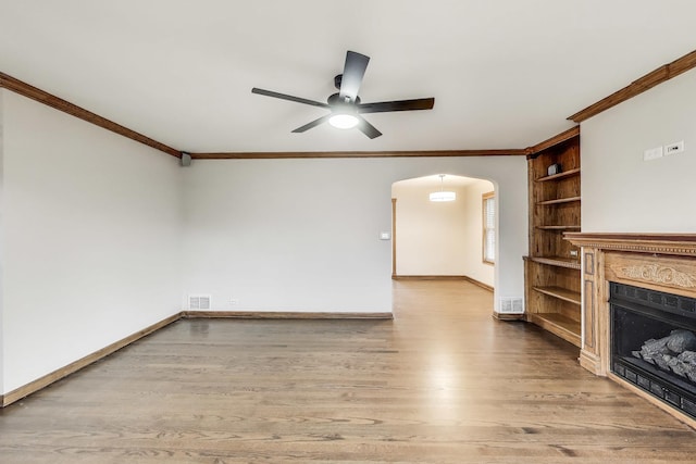 2004 Linden Ave, Park Ridge, IL 60068 - unfurnished living room with ornamental molding, arched walkways, a ceiling fan, light wood-style flooring, and a fireplace