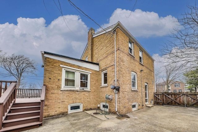 2004 Linden Ave, Park Ridge, IL 60068 - back of property with a deck, a patio area, a chimney, a gate, and brick siding