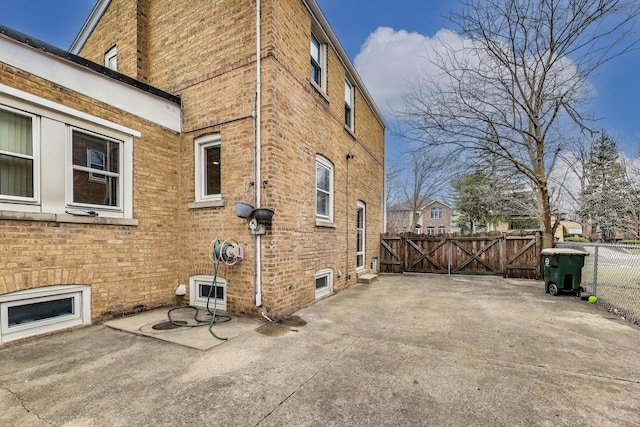 2004 Linden Ave, Park Ridge, IL 60068 - view of property exterior featuring brick siding, a gate, and a patio