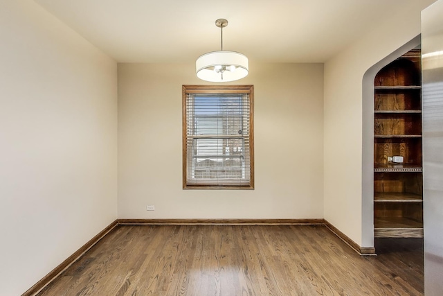 2004 Linden Ave, Park Ridge, IL 60068 - empty room with wood finished floors, baseboards, and arched walkways