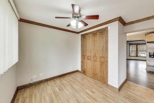 2004 Linden Ave, Park Ridge, IL 60068 - unfurnished bedroom featuring baseboards, light wood finished floors, crown molding, a closet, and a ceiling fan