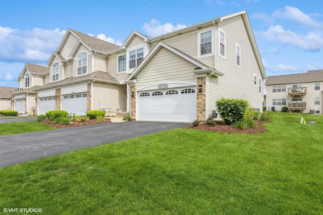 1708 S Fieldstone Dr, Shorewood, IL 60404 - townhome / multi-family property featuring asphalt driveway, stone siding, an attached garage, and a front yard