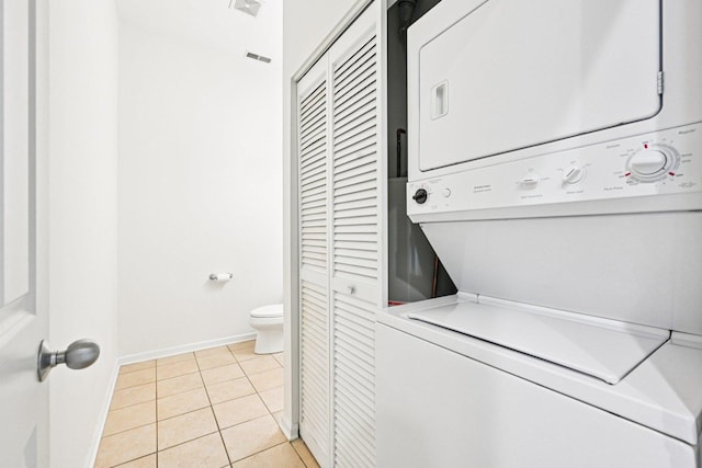 7511 Brown Ave Unit N, Forest Park, IL 60130 - washroom featuring stacked washer / dryer and light tile patterned floors