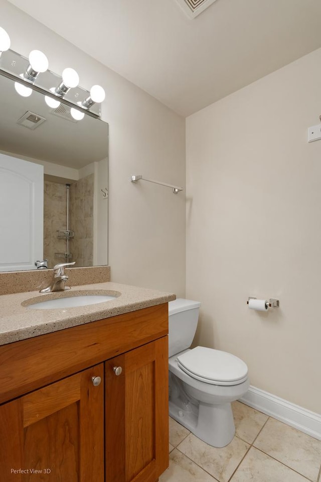 25 E 26th St Unit 4, Chicago, IL 60616 - bathroom with tile patterned floors, vanity, toilet, a tile shower, and baseboards